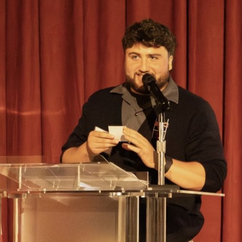 Men's Rugby President Andreas Angelopoulos ’25 MA, ’26 selects the raffle winner for the 2026 New Zealand Tour