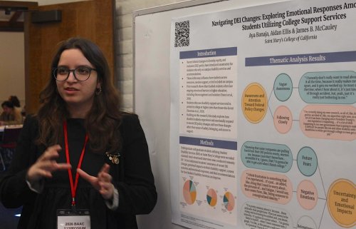 Aya Banaja ’26 with a poster at the Bay Area Autism Consortium meeting in March 2026