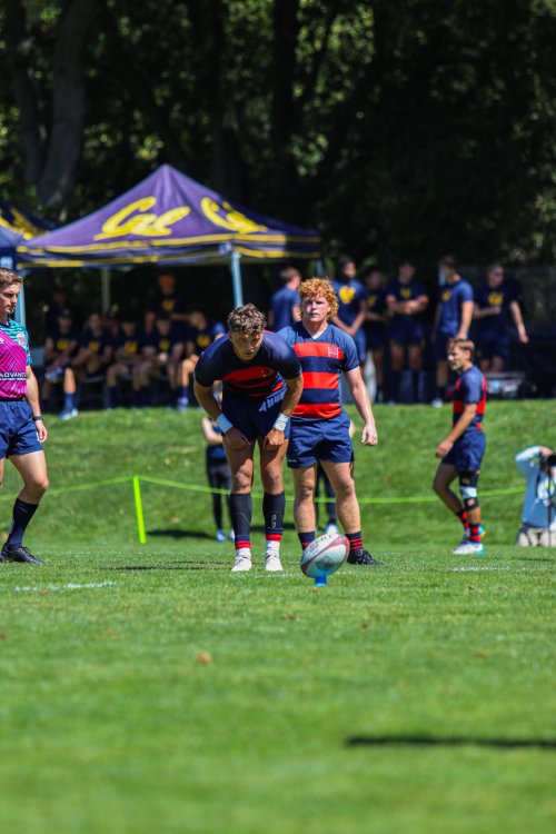 Saint Mary's player Oli Cline focuses on the rugby ball on the kick stand as he prepares to kick a penalty goal.