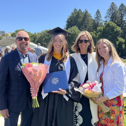 Jacquelyn Neuner at Commencement 2025 in regalia with family