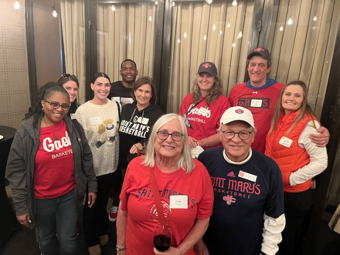 Ten people in SMC apparel smile at the camera