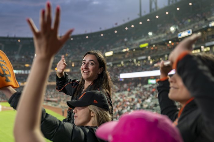 A student smiles at the SF Giants baseball game