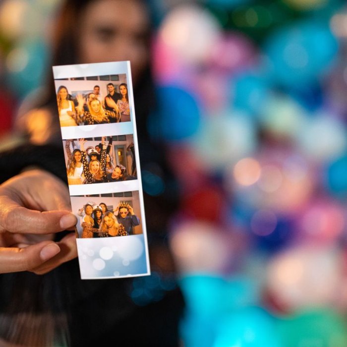 Photo of someone holding a picture strip from the photo booth