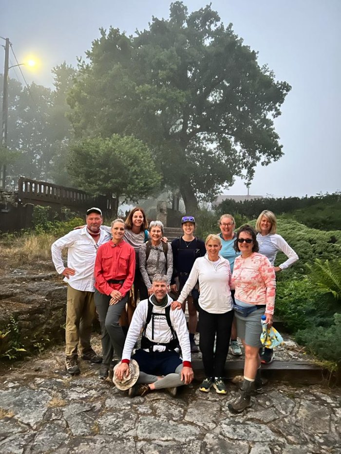 A group smiling on a misty morning on the Spanish Camino