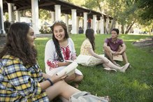 students sitting on the lawn at SMC