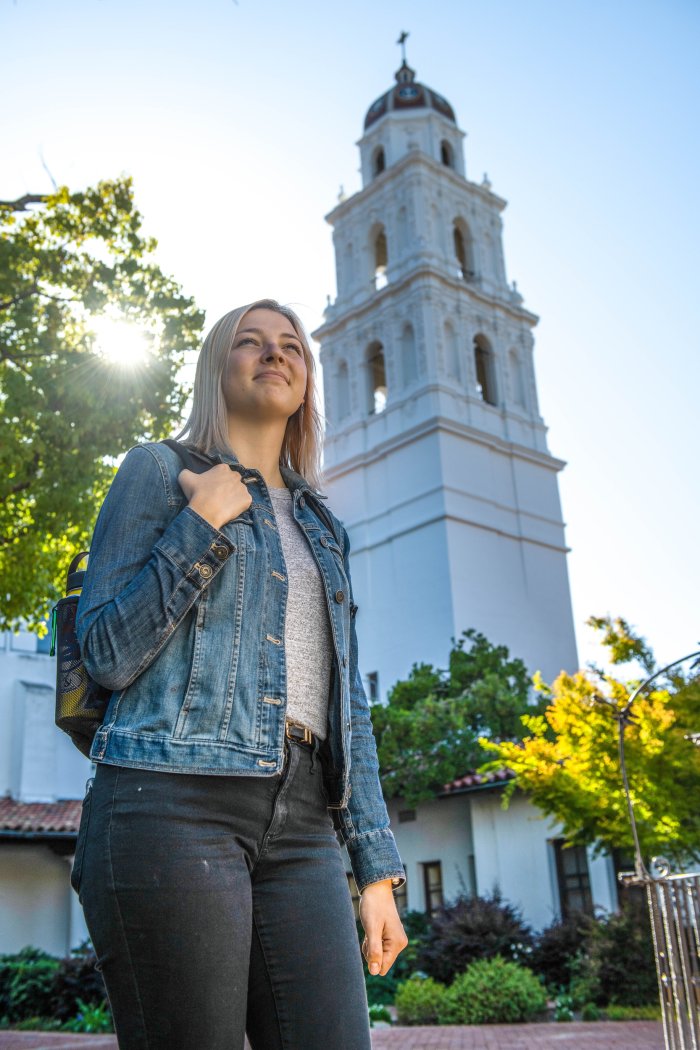 student standing in]front of church