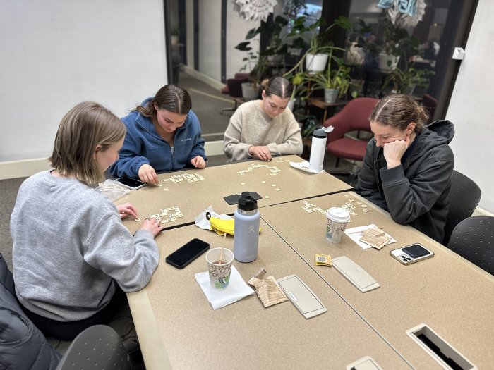 A group of students playing Bananagrams in the library