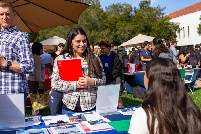 A student at Fall Preview Day at an Information Booth