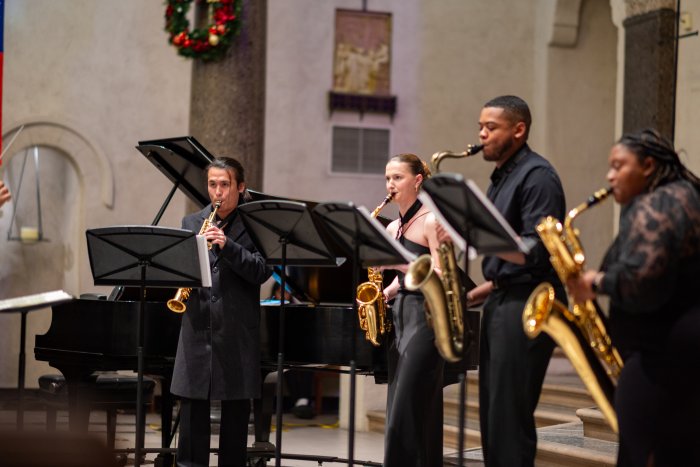 Four music students performing in the Chapel