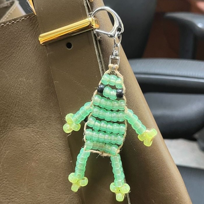 a keychain made out of green beads