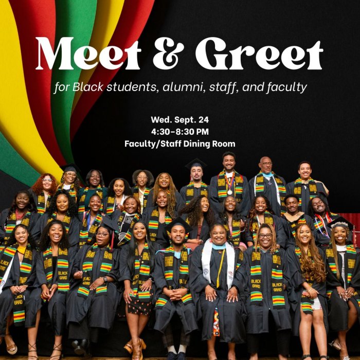 dozens of Black students wear graduation robes and Kente cloths