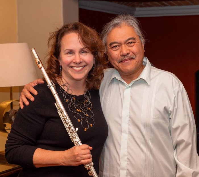 Amy Likar holding her flute with pianist Lino Rivera 