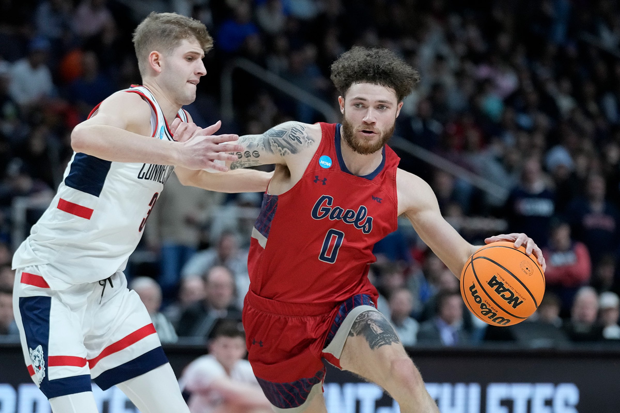 SMC basketball player Logan Johnson drives against University of Connecticut in NCAA Tournament on March 19, 2023