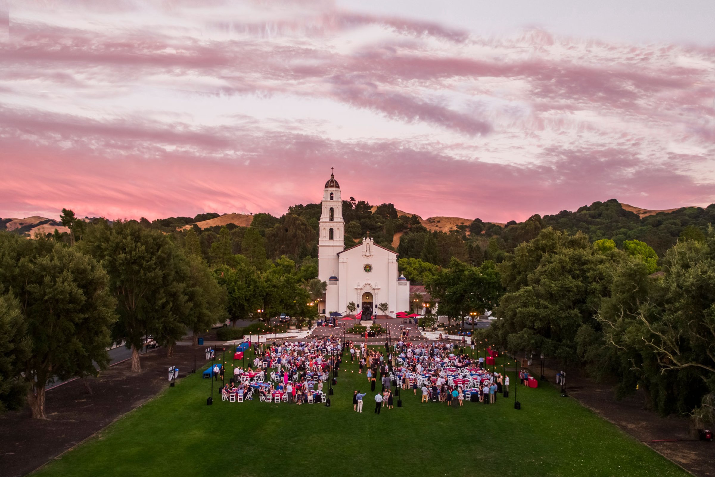 A Saint Mary's College campus event with tables and lights on the chapel lawn
