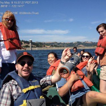 EES students on a fieldtrip, on a boat wearing life vests in a reservoir