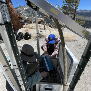 Mentor and research student servicing air monitor equipment in Devils Postpile National Park
