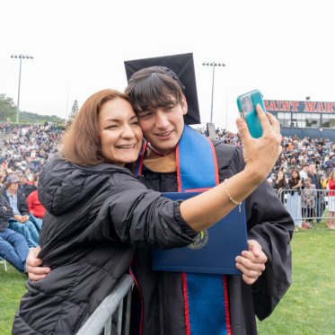 A graduating student and parent taking a selfie