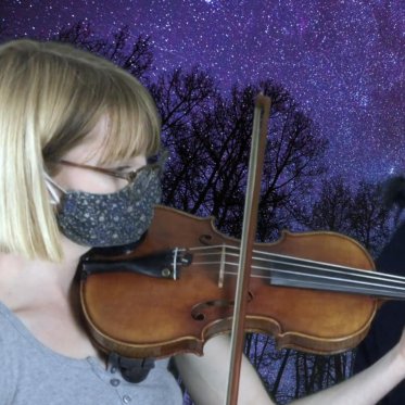 A photo of two music faculty members playing their instruments, set against a starry night sky superimposed behind them