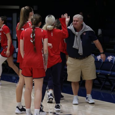 Roger high fives volleyball players
