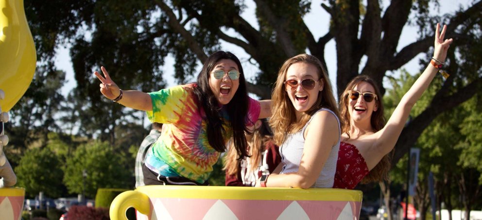 Students riding a tea cup at a carnival 