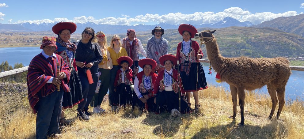 Students in Peru with alpacas and locals