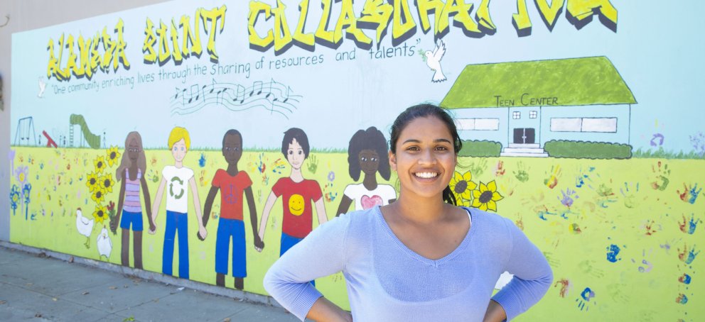 Student in front of mural