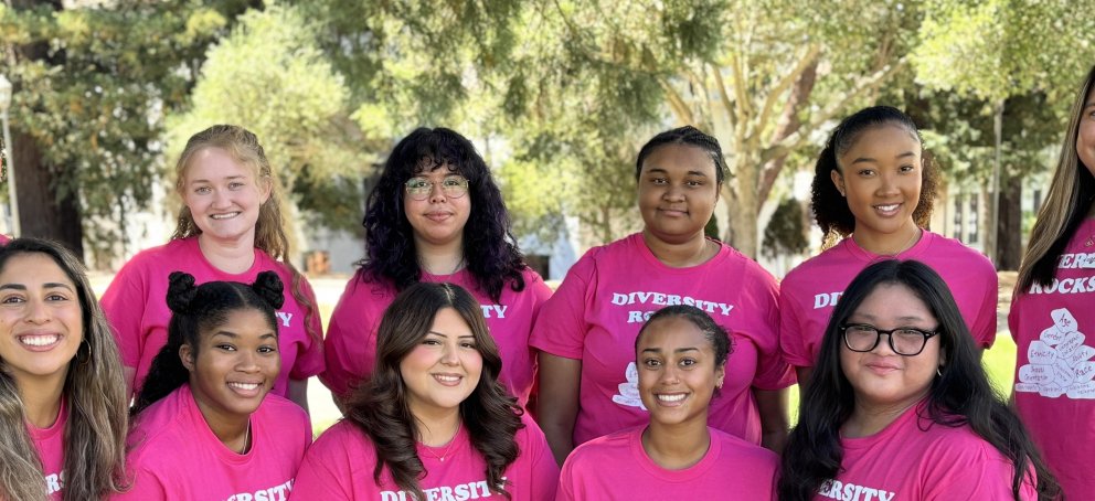 Pro-staff and student staff members of Intercultural Center wearing pink Diversity Rocks shirts