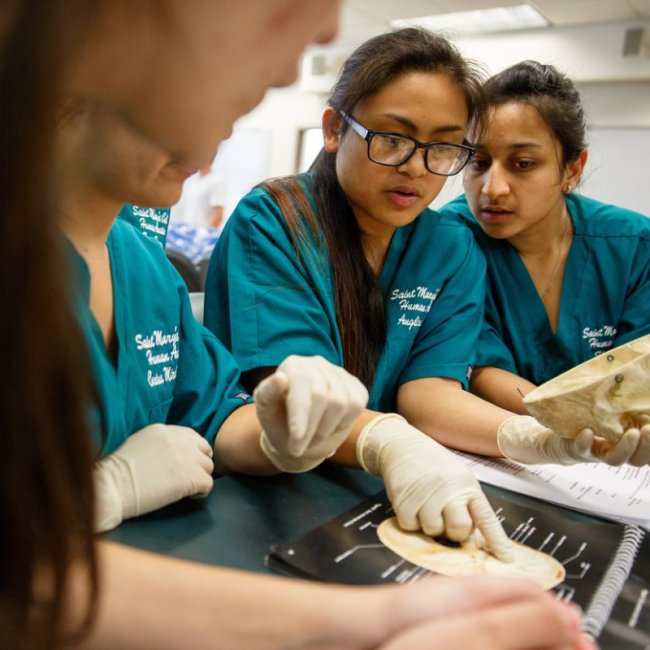 students in coats pointing with gloves