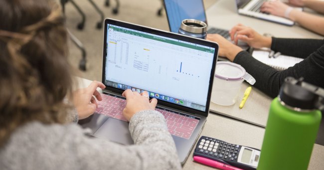 saint mary's student typing on keyboard pursuing economics degree