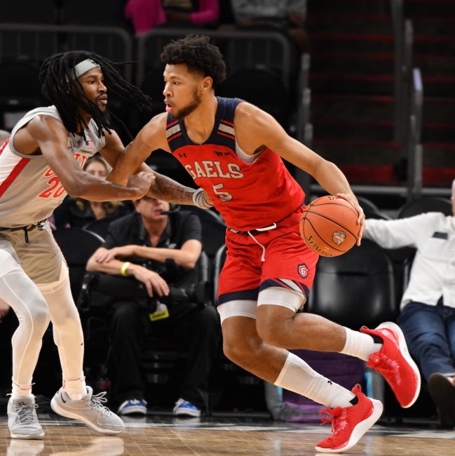 Men's Basketball player Joshua Jefferson drives against UNLV in December 2023