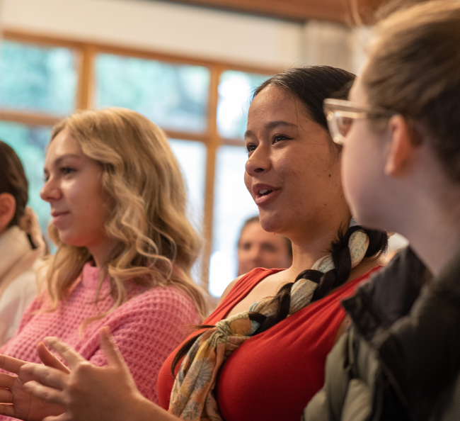 Studetns watching a staged play reading in Claeys lounge