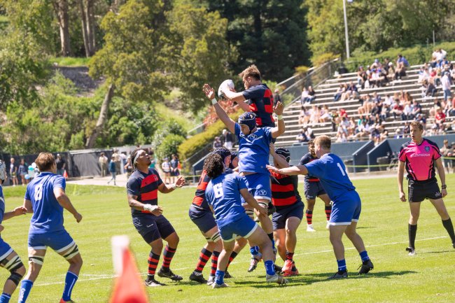 Finding a teammate: Lleyton Delzell ’23, MA ’24 secures the rugby ball from a line out pass and looks to King Matu ’24 to move it forward. / Photo by Rebecca Harper