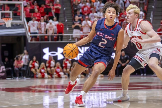 Men's basketball player Jordan Ross dribbles against Utah in December 2024