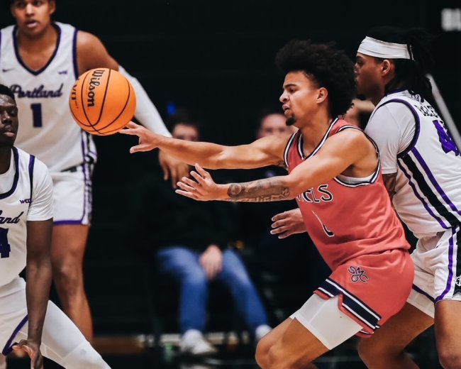 Men's basketball player Mikey Lewis passes against Portland in January 2025