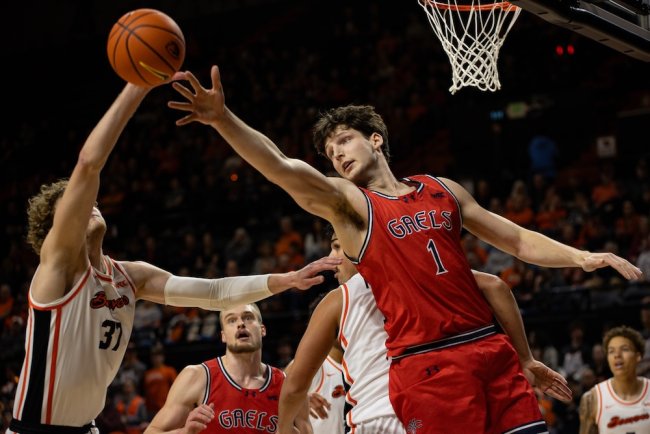 Men's basketball player Harry Wessels blocks a shot against OSU in February 2025