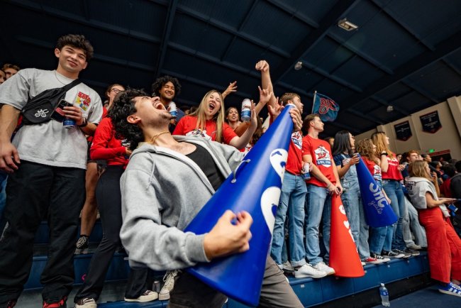 Students in Gael Force in a crowd at a men's basketball game in 2024-25 season