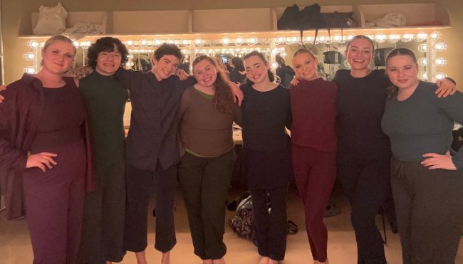 Eight dancers in dressing room after performance in NW regionals 2025