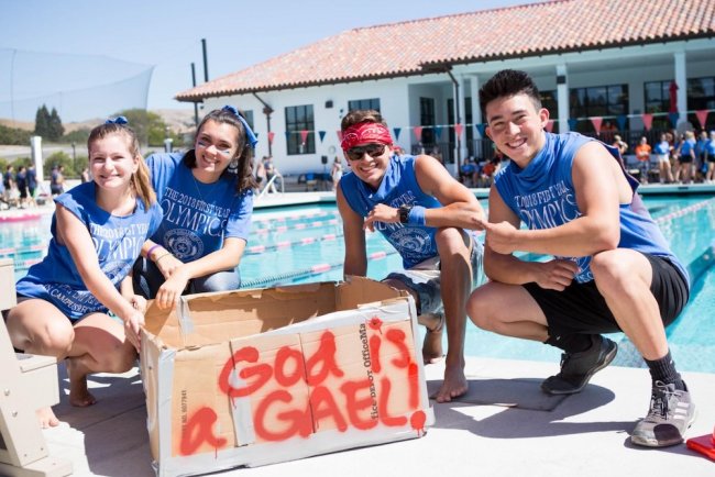 Students with cardboard boat for first year olympics boat race
