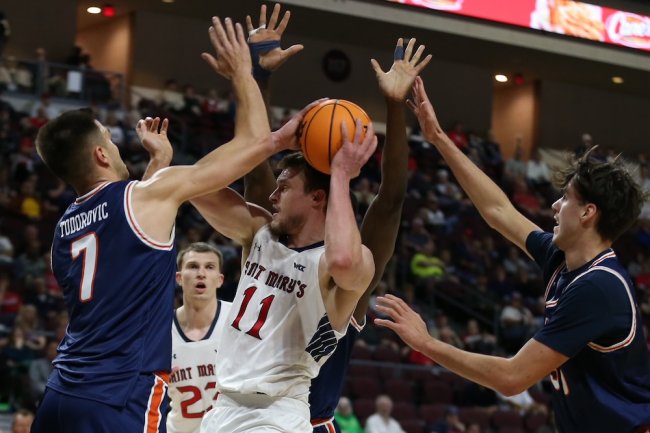 Men's Basketball player Mitchell Saxen tries to keep the ball away from Pepperdine at 2025 WCC Semifinals
