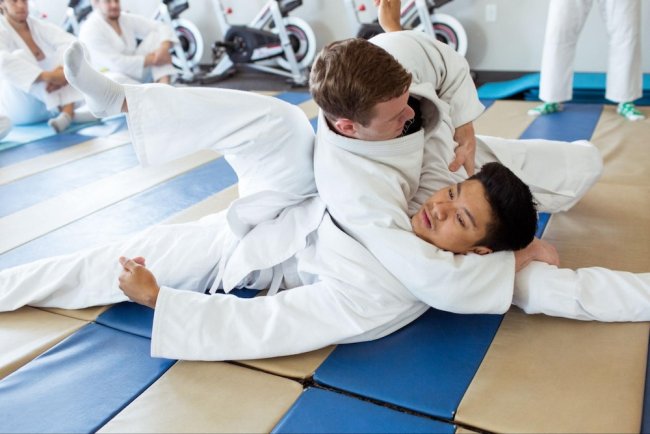 Two students practice martial arts