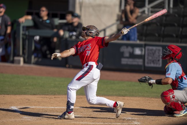 Gaels men's baseball player running after hit