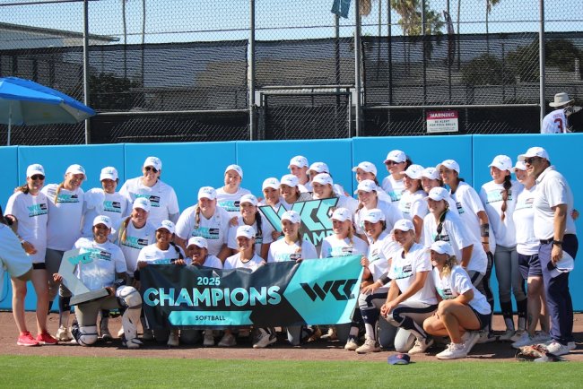 Softball team with 2025 WCC Champions banner