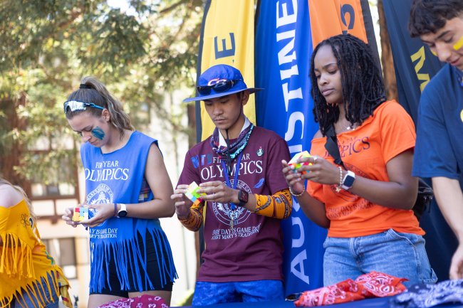 It’s a Pattern: Marc Thomas Valdez ‘29 from Aquinas Hall completes the Rubik’s cube puzzle before his competitors during the First Year Olympics and shares that solving the puzzles is just a repetitive pattern. / Photo by Rebecca Harper