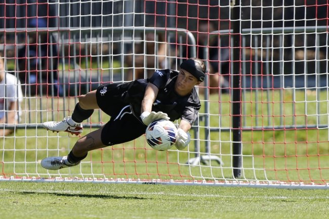 Soccer Player Kate Plachy dives to make a save against Boston University in August 2025