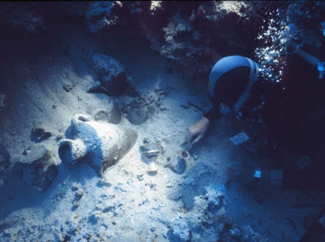 Student uncovering an underwater shipwreck