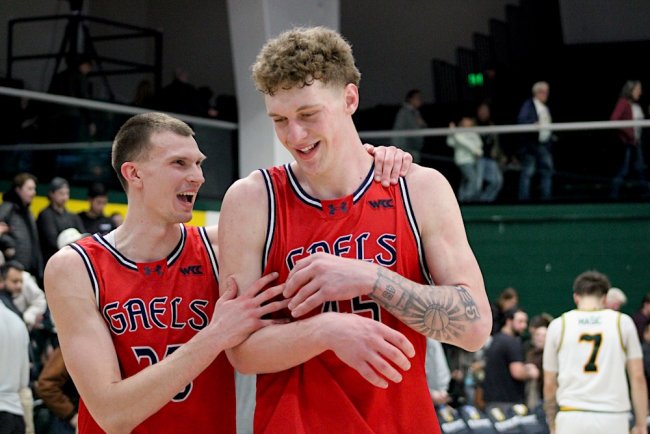 Basketball players Paulius Murauskas and Andrew McKeever smiling at a game against USF in January 2026