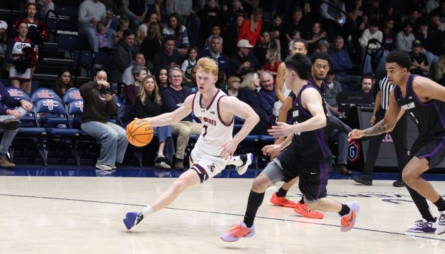 Basketball player Joshua Dent drives against Portland in January 2026