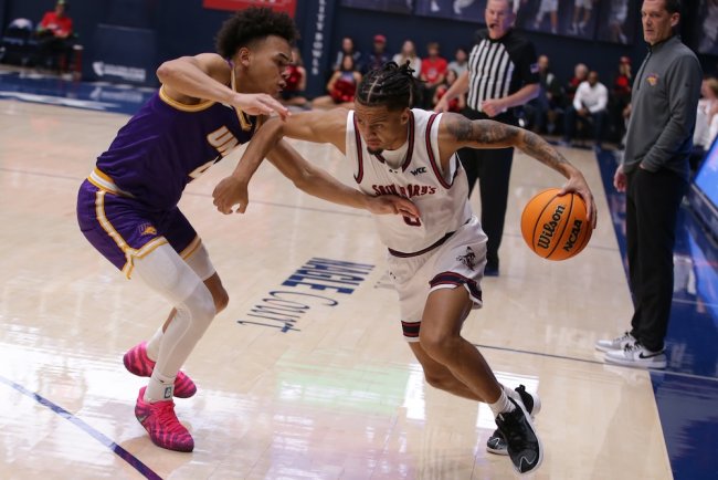 Basketball player Mikey Lewis drives against Northern Iowa in December 2025