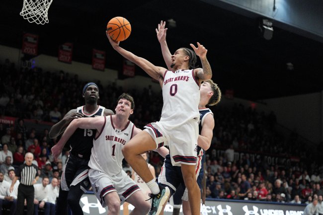 Basketball player Mikey Lewis shoots while teammate Harry Wessels guards against Gonzaga in February 2026