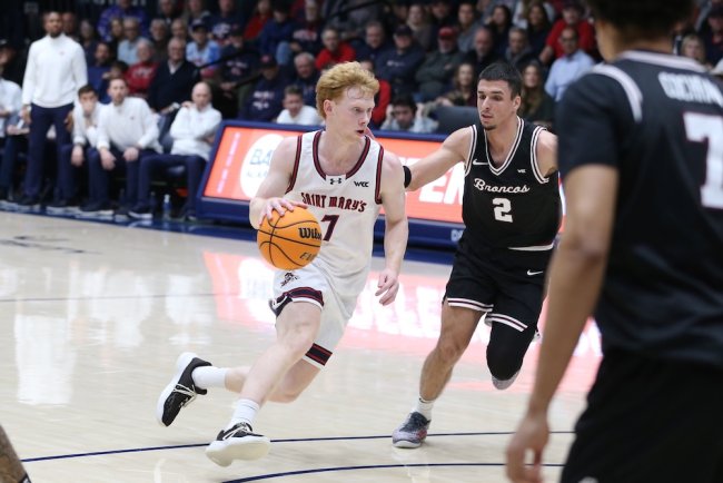 Basketball player Joshua Dent drives against Santa Clara in February 2026